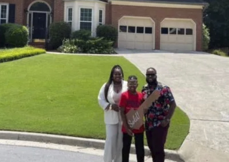 picture of Christopher T. in front of a house