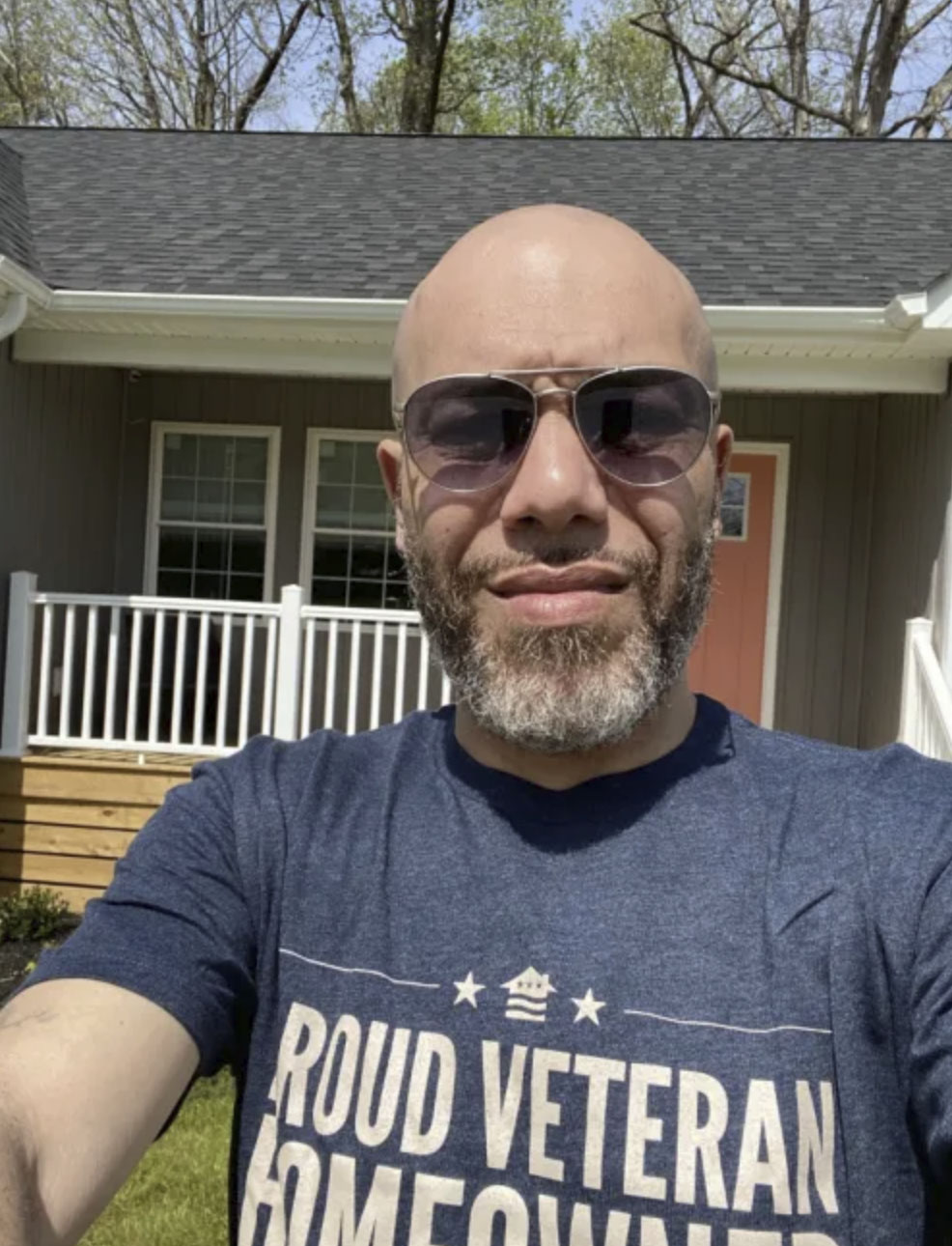 picture of Jabril M. in front of a house